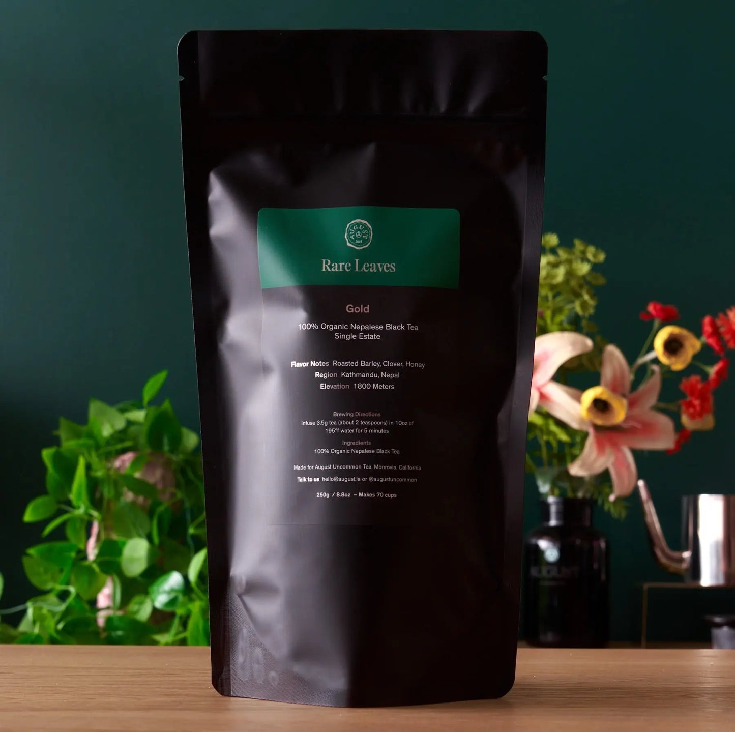 Gold black tea pouch, stand-up bag with green label and text