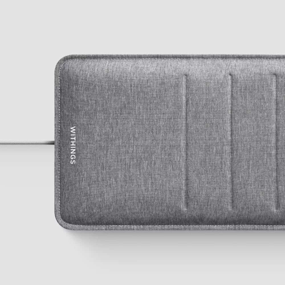 Withings sleep tracking mat close-up, grey fabric with Withings logo and seam