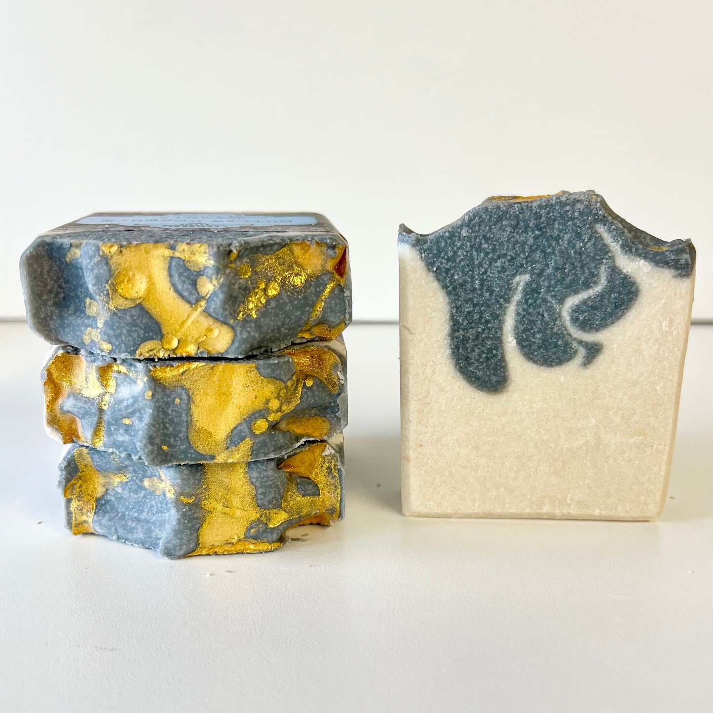 Sea salt soap bars: marbled blue-gray and gold, and a cream bar with blue swirl