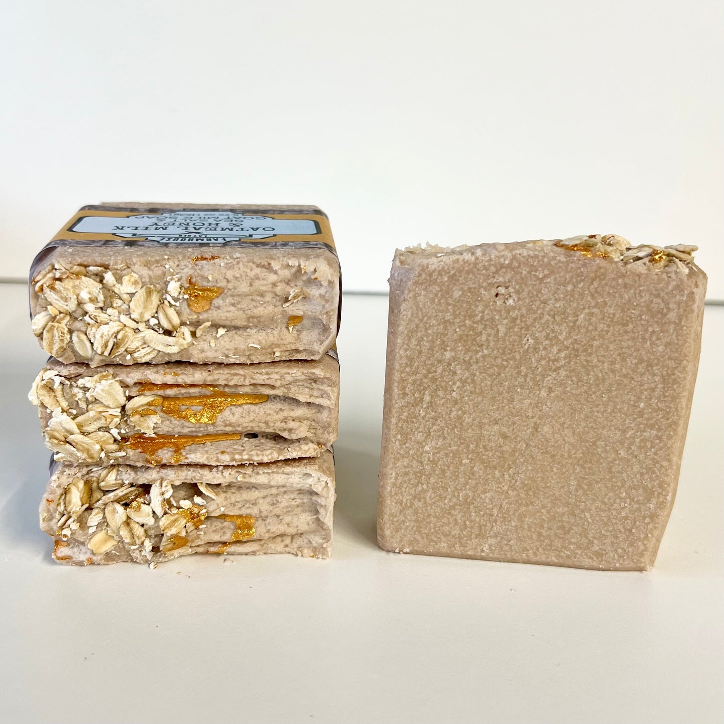 Oatmeal soap bar stack with oats and gold flecks, plus single bar side view
