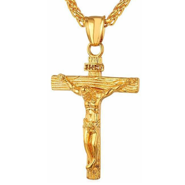 Gold cross pendant necklace with crucifix design and curb chain