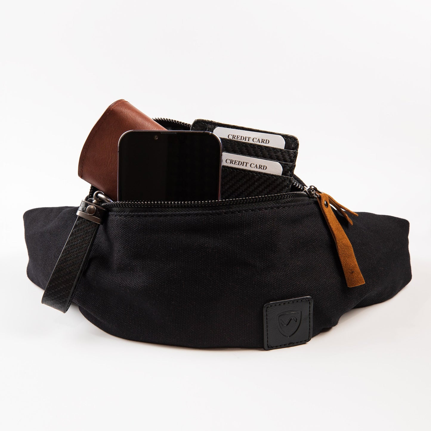 Canvas crossbody fanny pack, black; open pocket with card slots and tan pull tab