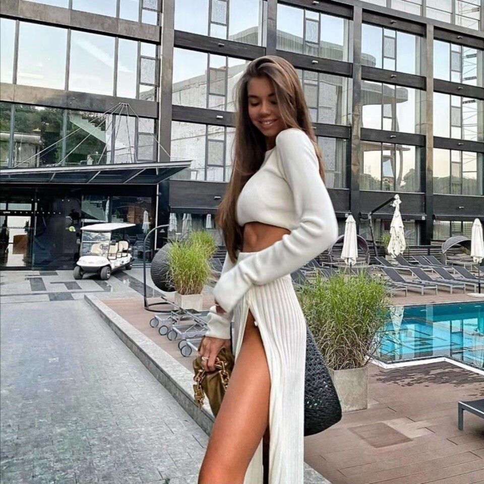 Ivory knitted two-piece: long-sleeve crop top with high-slit pleated skirt