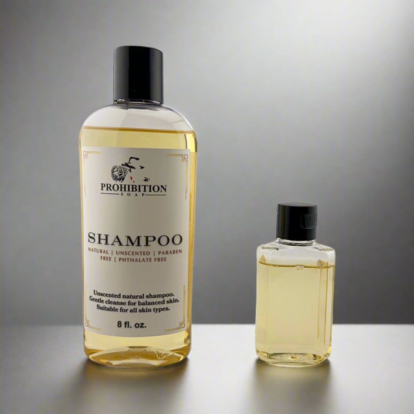 Shampoo bottle set with large and small bottles, black caps, pale yellow liquid