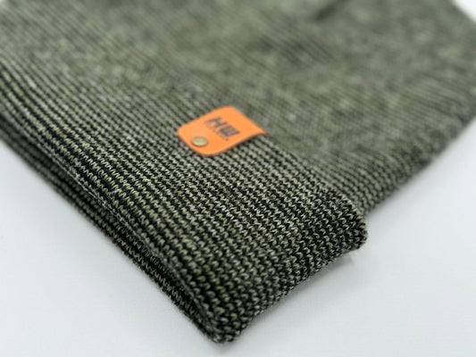 Dark green knit cuff beanie corner with small orange logo label