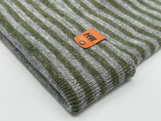 Striped knit beanie cuff with orange logo patch label on folded edge