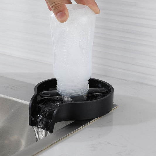 Black cup washer basin with cup inserted and water flow into sink