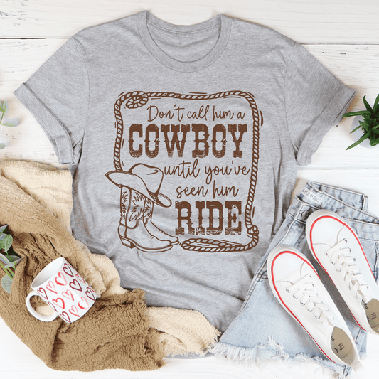 Heather gray cowboy graphic T-shirt with slogan, cowboy hat, and boots print