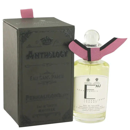 Women’s perfume bottle with pink ribbon and glass cap, beside matching gift box