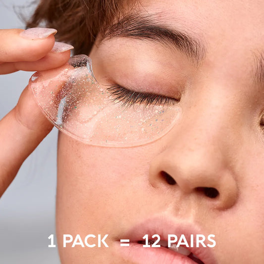 Shimmering under-eye gel patch on eyelid area, being applied with fingertip