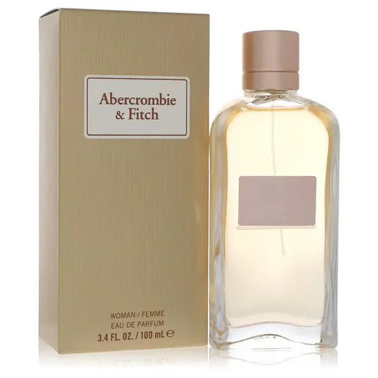 Women's perfume bottle with rose-gold cap and beige box, Abercrombie & Fitch, clear glass.