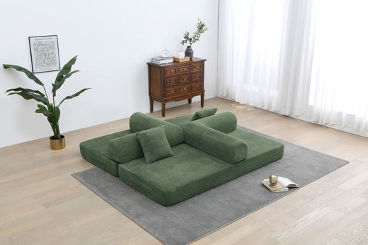 Army green foldable sofa bed with armrests and bolster pillows, open for sleeping