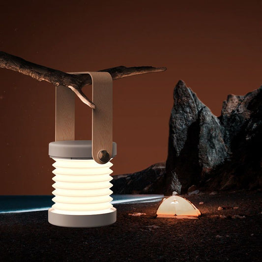 Portable LED lantern night light with beige frame, ribbed body, and warm glow