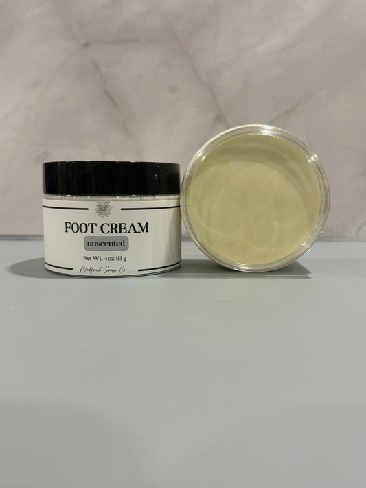 Foot cream jar with black lid, lavender-scented pale yellow cream, open