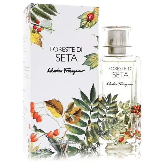 Unisex eau de parfum bottle with gift box, leaf and berry artwork, clear glass