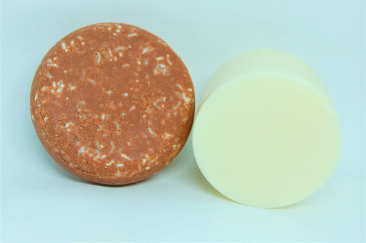 Round shampoo bar, brown with specks, and a pale yellow bar
