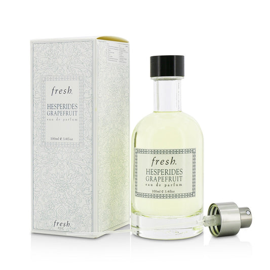 Fresh eau de parfum bottle with sprayer, black cap, pale yellow liquid, box