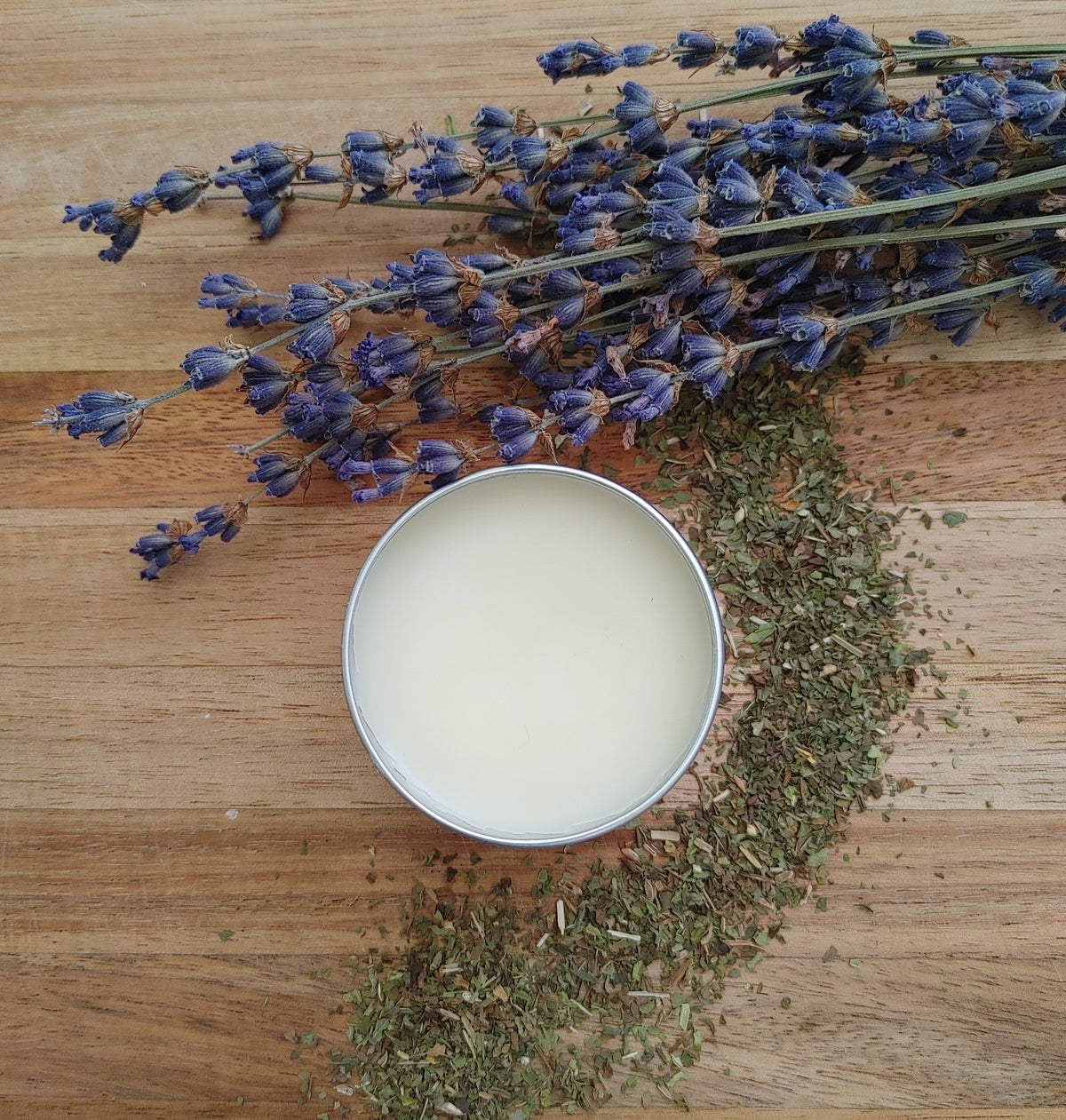Round lip balm tin filled with pale cream balm