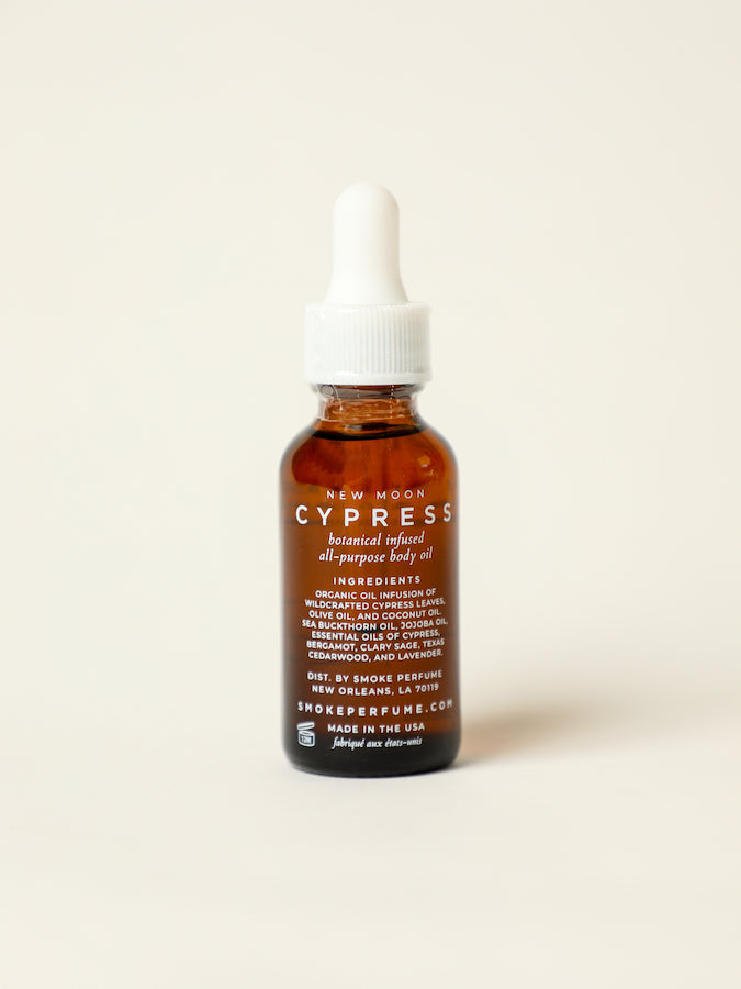 Cypress body oil bottle back label view, amber glass with white pump