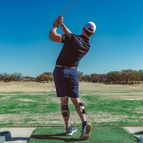 Golf practice turf with small dark pads at the base