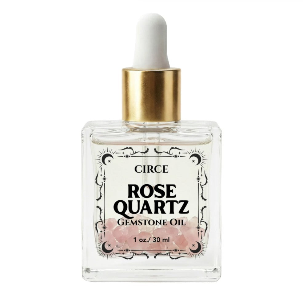 Rose Quartz gemstone body oil bottle with white dropper and gold cap