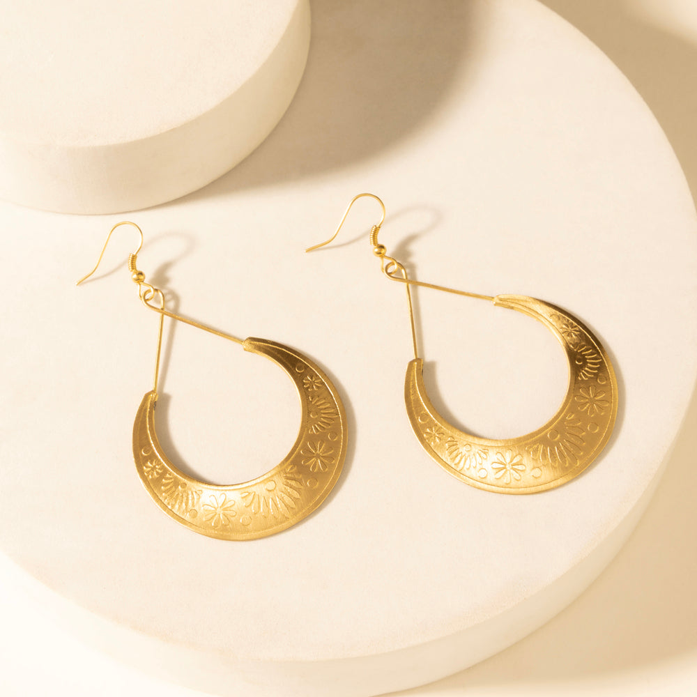 Gold-tone crescent drop earrings with engraved rim design and fishhook backs