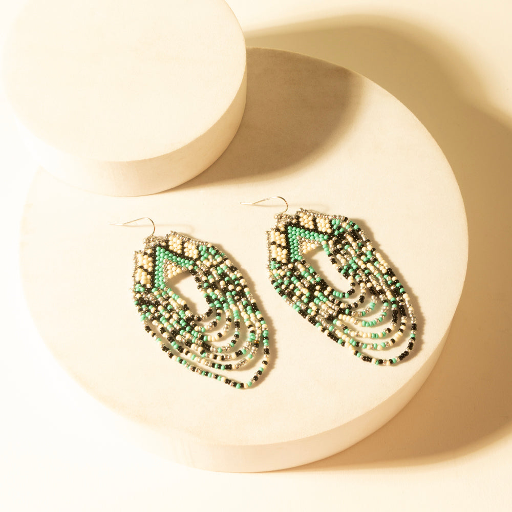 Beaded turquoise teardrop dangle earrings, two pairs shown with gold-tone hooks