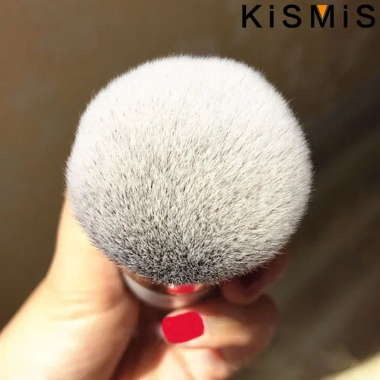 Round powder brush head with dense gray bristles on a white handle
