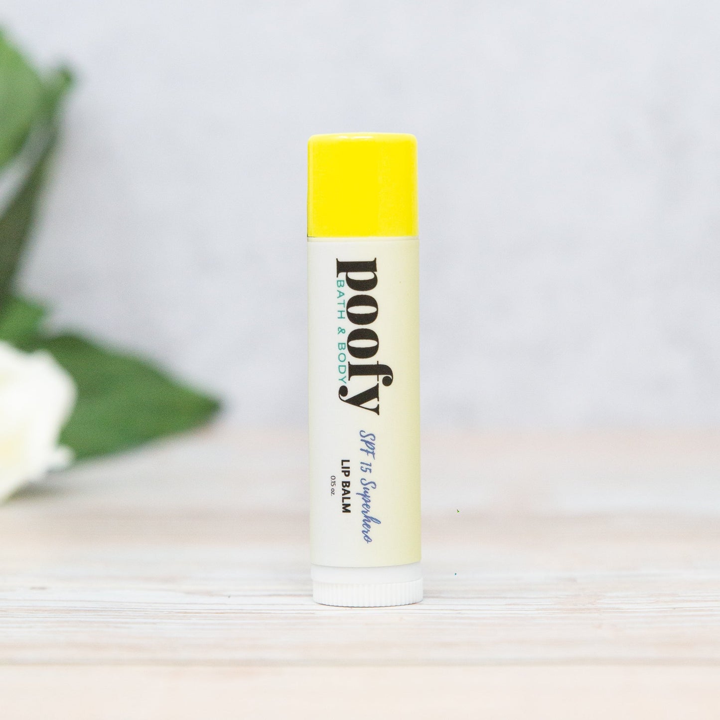 Lip balm with yellow cap in white tube, SPF 15