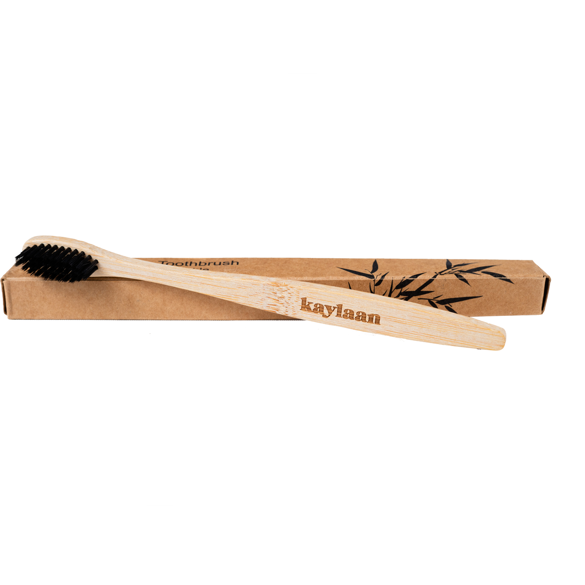 Bamboo toothbrush in cardboard box with black bristles and bamboo handle