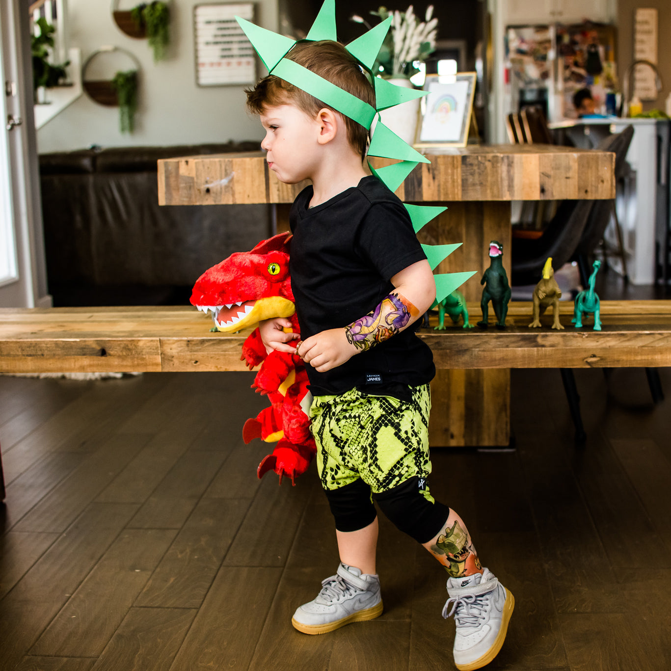 Kids temporary dinosaur tattoo sleeve on arm, colorful dino art in profile
