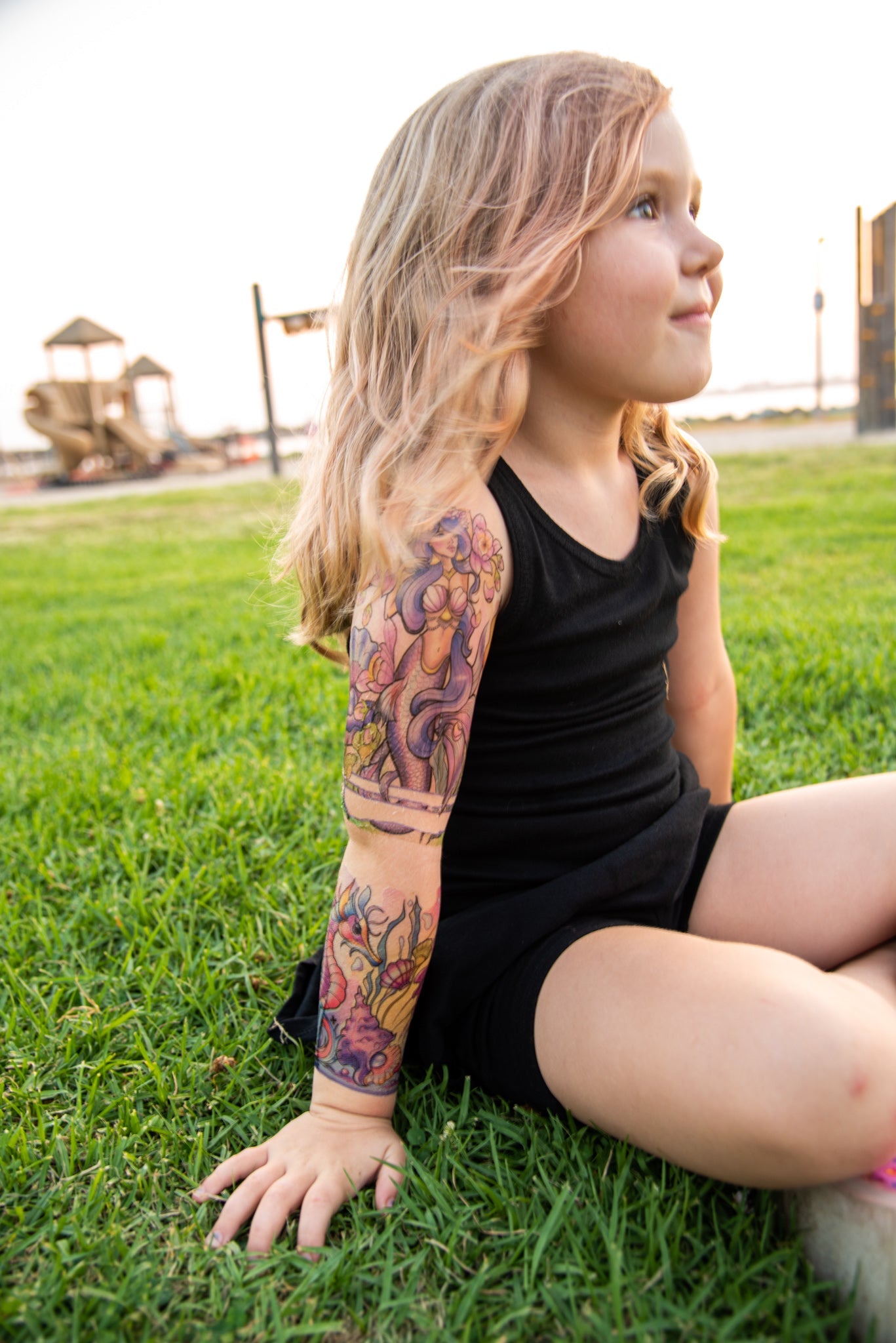 Temporary kids under-the-sea tattoo sleeve on child’s upper arm with mermaid sea life