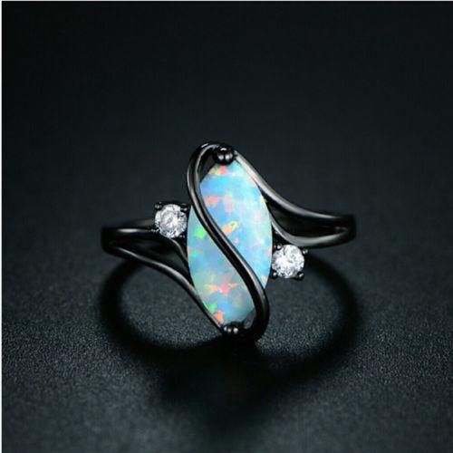 Black metal opal ring, oval marquise opal center with two round clear stones
