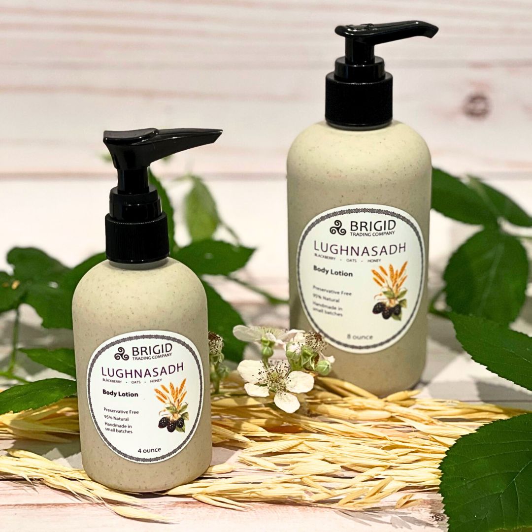 Two Lughnasadh body lotion bottles, 4 and 8 ounce, beige speckled with black pumps