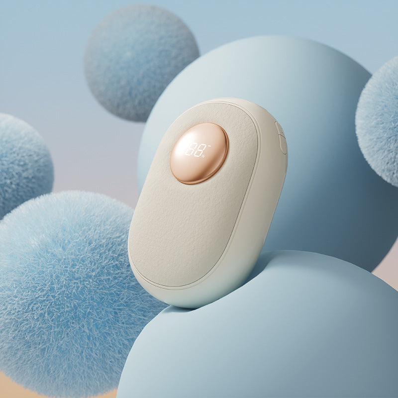Light beige electric hand warmer on blue pads; circular display reads 88°C