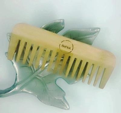 Bamboo hair comb with wide teeth and smooth handle, light brown wood.