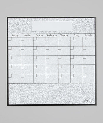 Dry erase calendar board with empty weekly grid, paisley swirls near bottom, framed