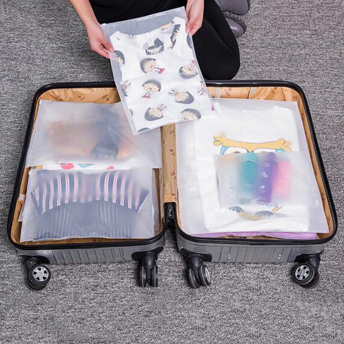 Open rolling suitcase with clear mesh clothing bags and patterned packing pouches