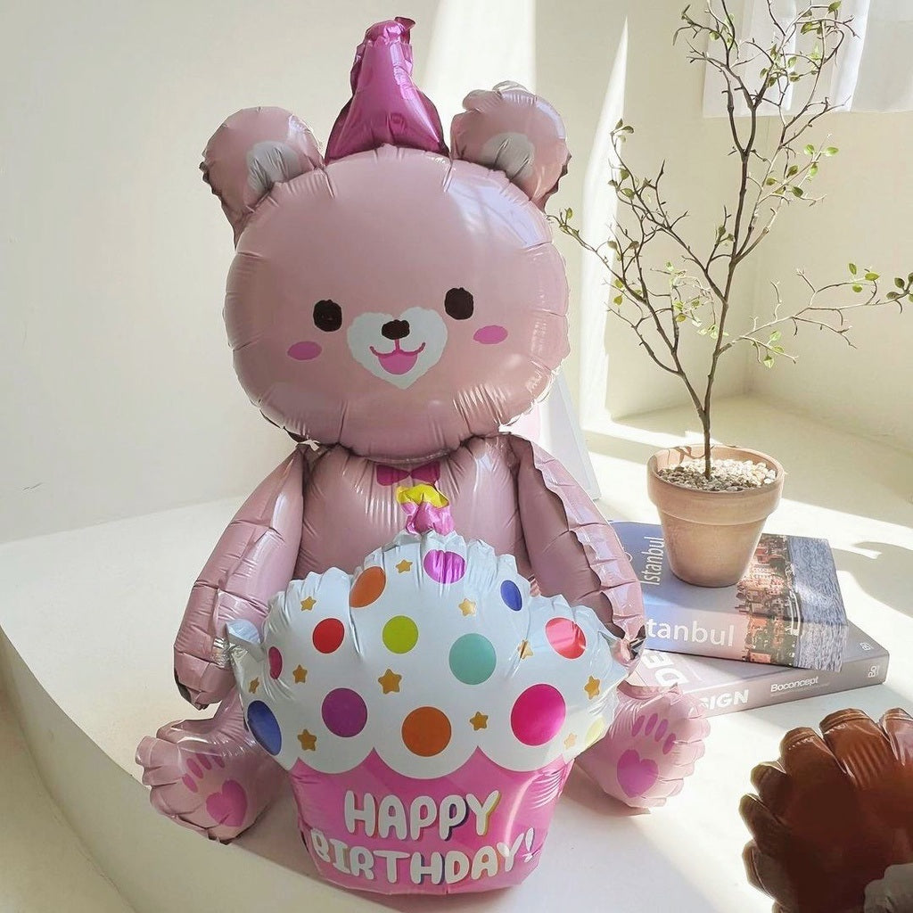 Pink bear foil balloon with party hat and “Happy Birthday” text