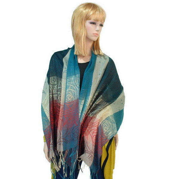 Pashmina shawl draped over shoulders in teal, red, and beige with tassel fringe ends
