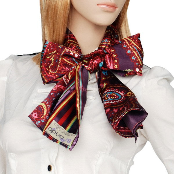 Silk neck scarf tied with dark purple, red paisley, and rainbow striped tails