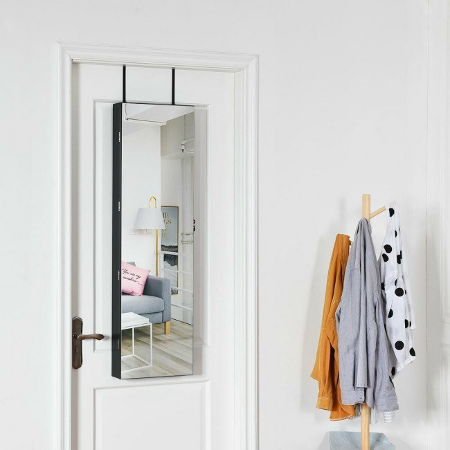 White wall-mounted mirrored jewelry cabinet door with open storage interior