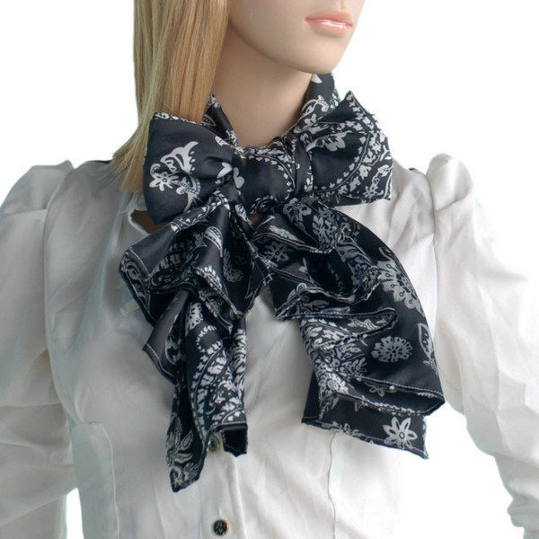 Black silk scarf tied at neck, white floral paisley pattern