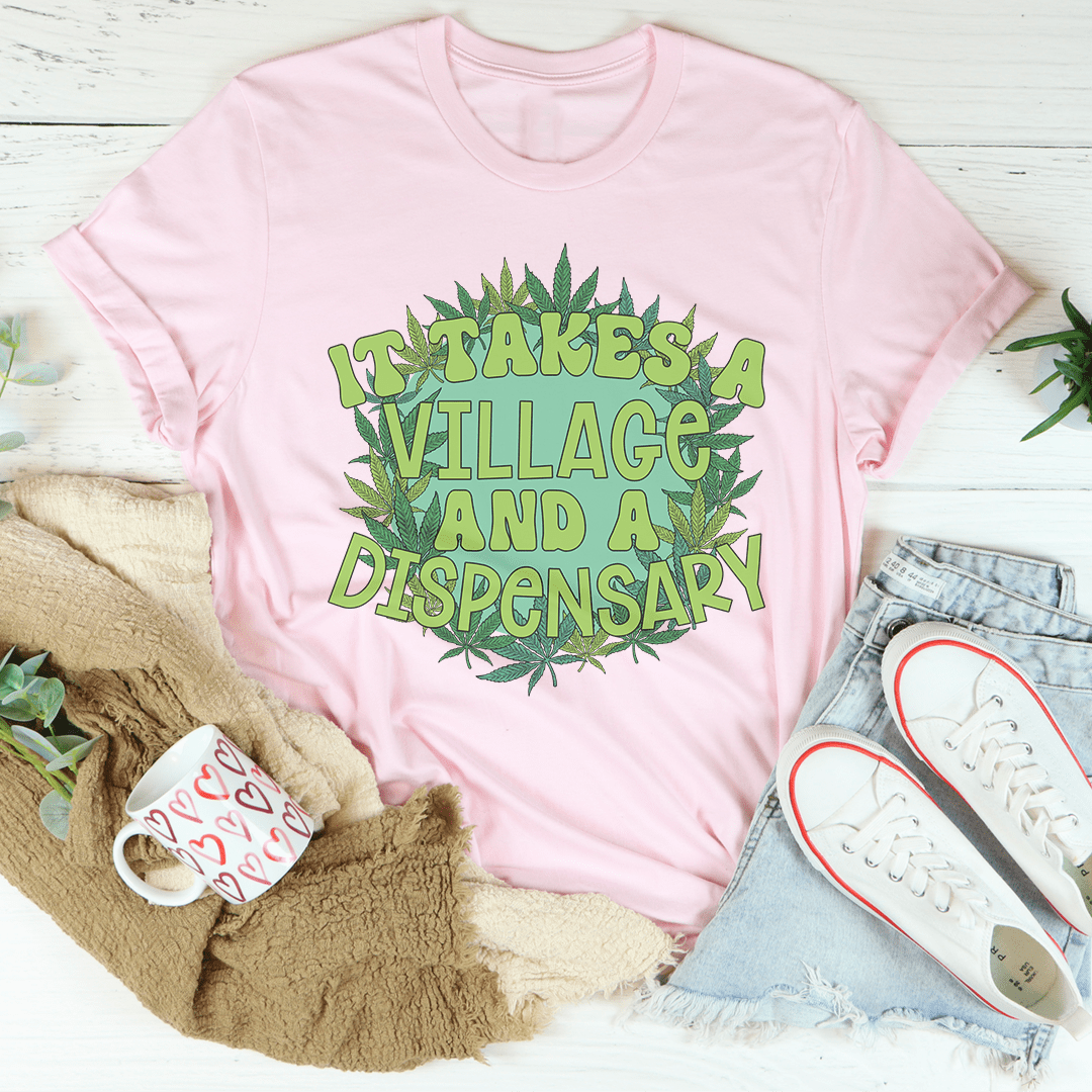 Light pink crewneck T-shirt with central green 'Take a Village and a Dispensary' print