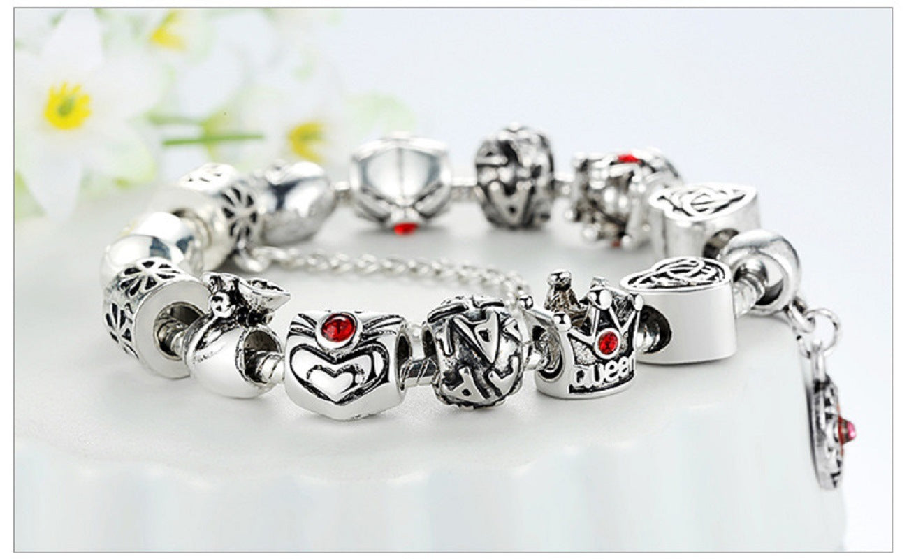 Silver charm bracelet with red enamel heart and flower charms, round bead links and clasp
