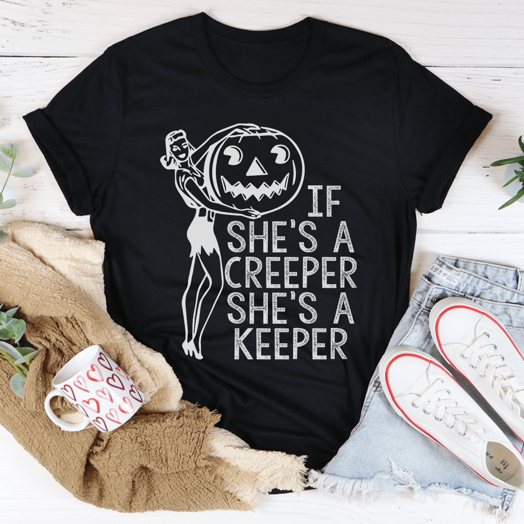 Black graphic tee featuring a witch with jack-o-lantern and 'If she's a creeper she's a keeper'