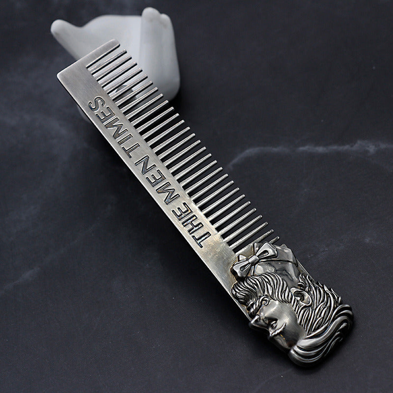 Stainless steel comb with fine teeth, lion-face handle and engraved lettering on bar