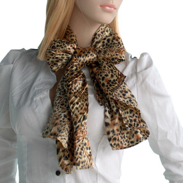 Leopard print scarf tied in a bow at model’s neck with long tails