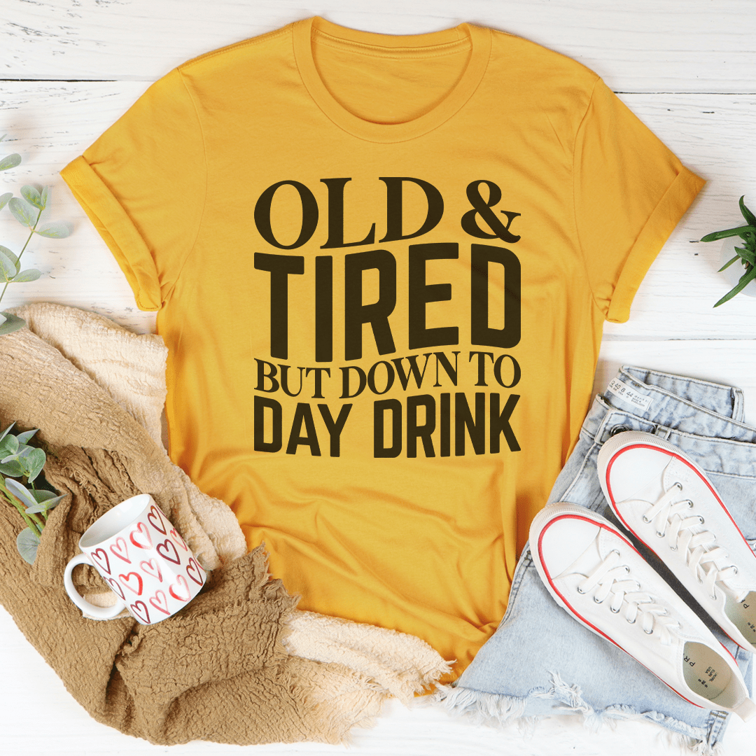 Mustard yellow crew-neck t-shirt with 'OLD & TIRED' typography and 'DAY DRINK' text