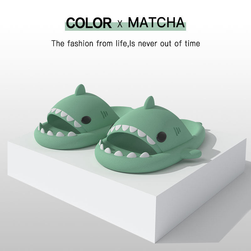Matcha green shark-shaped slide sandals with molded white teeth, open toe design.